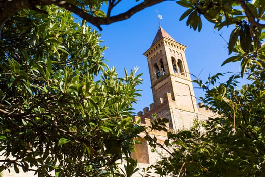 Saints Joseph and Christoper church, Bolgheri Tuscan IT- November 2, 2014. View through the trees of a medieval church.