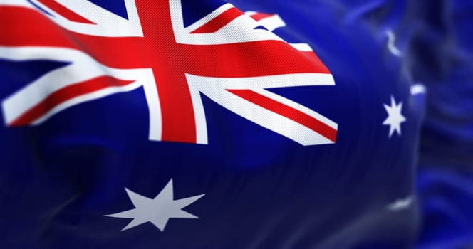 Close-up view of the Australia national flag waving. The Commonwealth of Australia is a state located in Oceania. Fabric textured background. Selective focus. 3D illustration