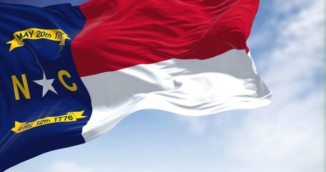 Close-up view of the North Carolina state flag waving. North Carolina is a state in the Southeastern region of the United States. Fabric textured background. Selective focus. 3D illustration