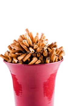 Full bowl of cigarettes end over white background