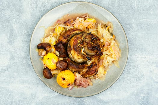 Roasted knuckle of pork with cabbage and beer. Traditional German recipe.