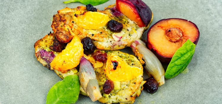 Meat chop cooked with plums and tangerine. Baked meat steak