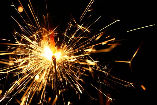 yellow sparkler holiday background on black