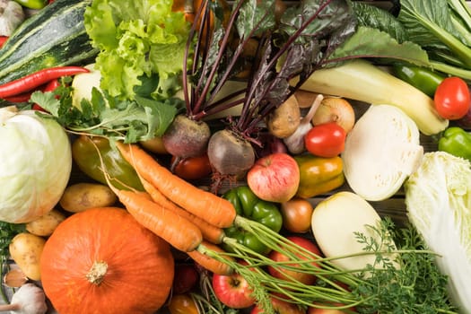 Abundance of vegetable, fruit food collection of onion, apple, pumpkin, cabbage carrot, pepper, tomato, garlic and potato. Homegrown produce, farm product and organic consumption. Full frame, top view