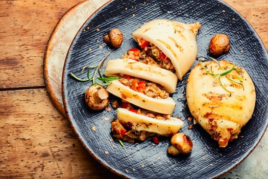 Grilled squids with vegetable stuffing. Stuffed calamari in grill pan