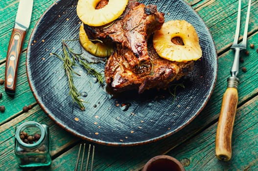 Grilled pork chop steak in pineapple syrup on the plate