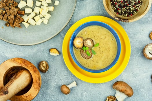 Tasty autumn soup on table. Yummy cream soup from champignon mushrooms.