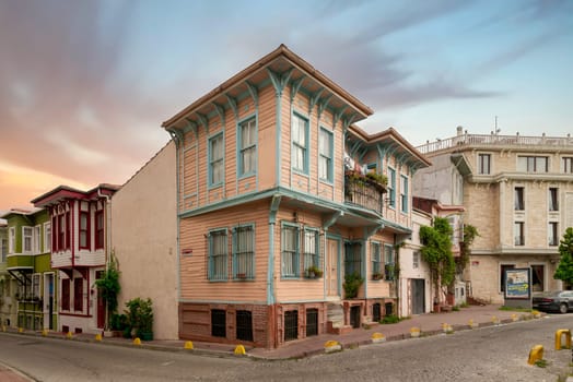 Exterior facade of old colorful wooden residential buildings balconies, and climber plants, Fatih district, Istanbul, Turkey