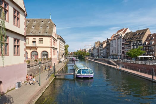 Old town of Strasbourg in France with a landing stage for excursion boats on the river Ill