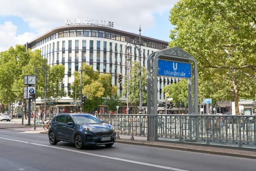Street scene with a car at Uhlandstrasse subway station on Kurfuerstendamm in Berlin