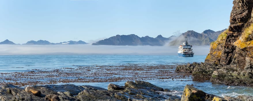 An Antarctic expedition ship lies at anchor off the coast of South Georgia - Widescreen Panorama