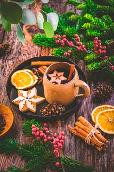 Mulled wine in white rustic mugs with spices and citrus fruit