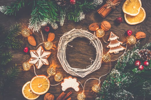 Christmas background with ornaments, spices and gingerbread on wooden background