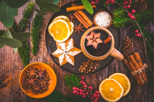 Mulled wine in white rustic mugs with spices and citrus fruit