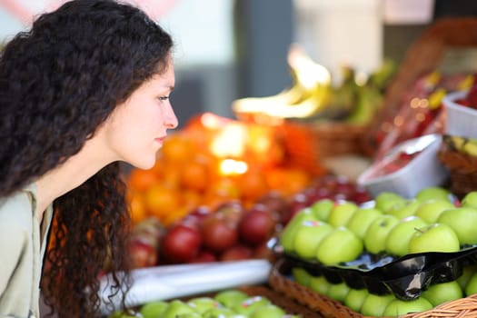 Close up of a woman choosing vegetables in a greengrocery
