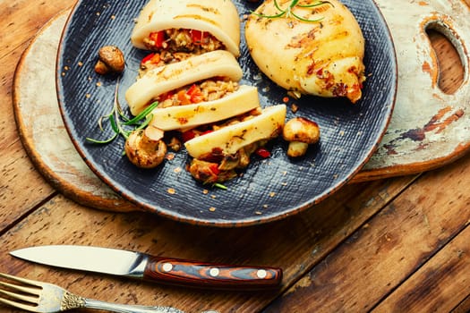 Appetizing grilled squids with vegetable stuffing. Roasted stuffed squid. Mediterranean dish, top view