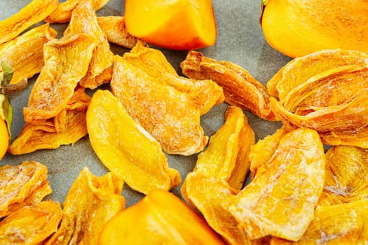 Dried persimmon with fresh persimmon on the table. Dried exotic fruit
