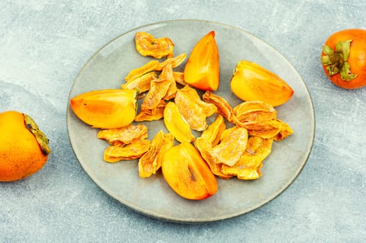 Dried persimmon with fresh persimmon on the table. Dried exotic fruit