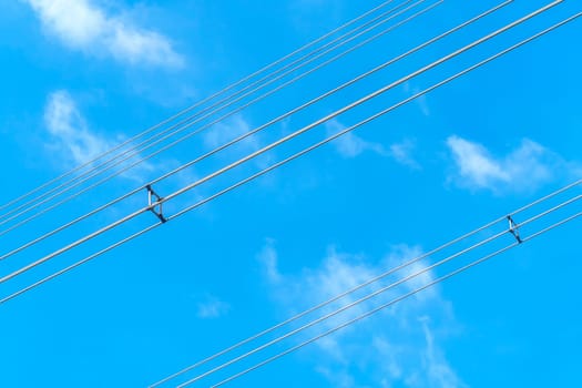 Wires power high and blue sky background.