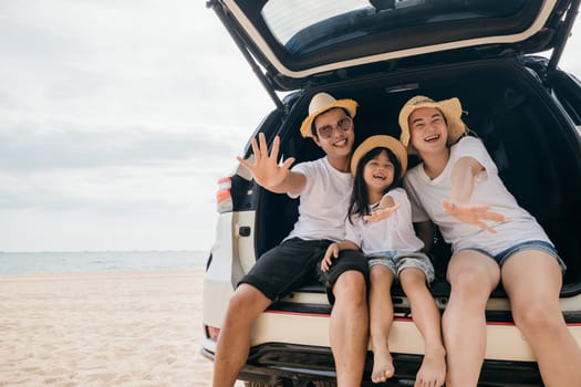 Family Day. Parents and children daughter enjoying road trip sitting on family back car motion wave to camera, Family traveling in holiday at beach, Happy people having fun in summer vacation on beach