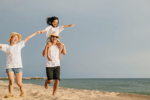 World Tourism Day. Happy people having fun in summer vacation on beach, Family traveling in holiday running race at sand beach, Dad, mom and child daughter enjoying road family trip playing together