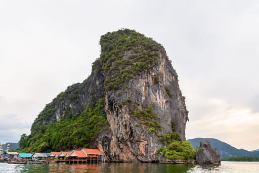 Landscape Koh Panyee or Punyi island home is floating over the sea during a boat tour at the Ao Phang Nga Bay National Park, Thailand