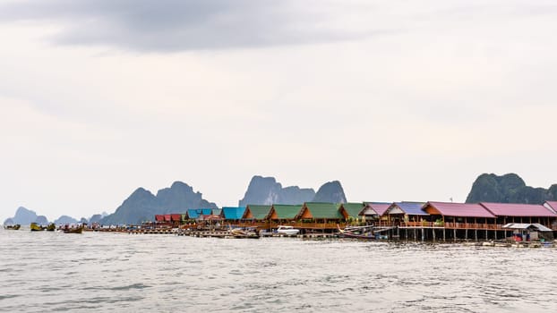 Pier and restaurants floating over the sea at Punyi Island or Koh Panyee during a boat tour in the Ao Phang Nga Bay National Park, Thailand, 16