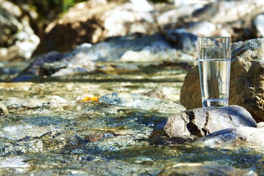 Water glass by a stream