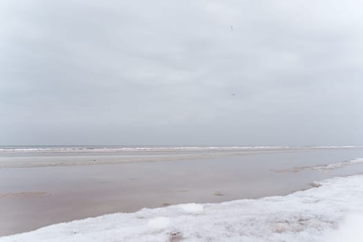 Baltic Sea coast on a winter cloudy day in Jurmala. Latvia