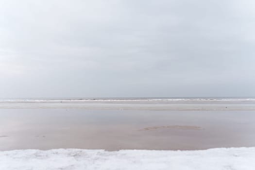 Winter seascape in the middle of a cloudy day. Baltic sea, Jurmala, Latvia.