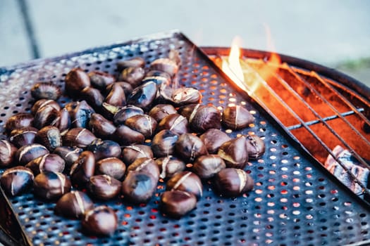 Grilling chestnuts being sold at stalls in autumn.