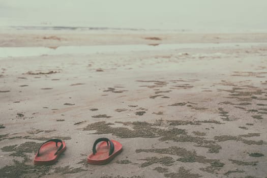Red shoes on the beach on daylight