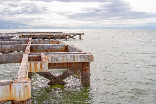 Pillars of old cement in the sea.