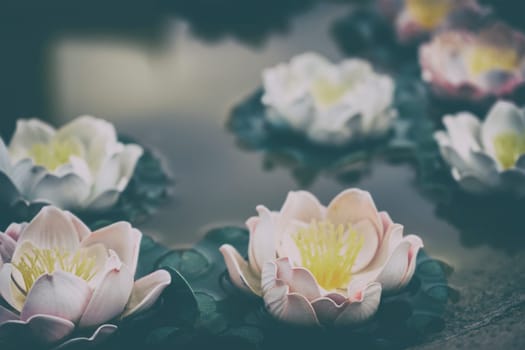 Floating plastic flowers in garden colorful background