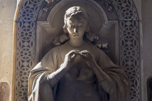 GENOA, ITALY - June 2020: antique statue, beginning 1800, made of marble, in a Christian Catholic cemetery - Italy