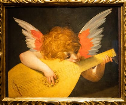 Florence, Italy - Circa August 2021. Angel playing a lute by Rosso Fiorentino, c.1521 - oil on panel