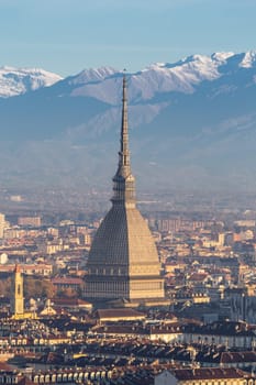 Turin, Italy - Circa November 2021: panorama with Alps and Mole Antonelliana,. Skyline of the symbol of Piedmont Region from Monte dei Cappuccini - Cappuccini's Hill. Sunrise light.