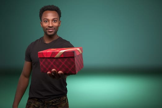 man giving christmas gift box generosity surprise holiday celebration present on copy space background