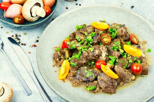 Chicken liver prepared with mushrooms and tomatoes. Liver in Georgian