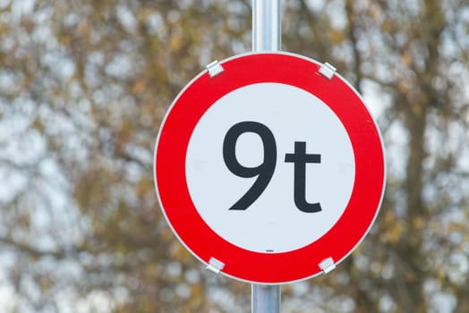 9t street sign next to a field