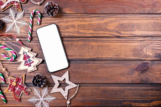 Smartphone mock up with rustic Christmas decorations for app presentation. View from above