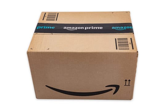 WETZLAR, GERMANY 2022-04-25: Amazon Prime parcel over white background. Prime is a service offered by online retailer Amazon for faster delivery of orders.
