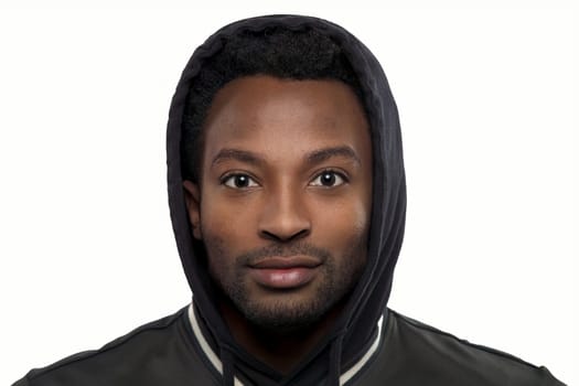young man wearing black hoody on white background student headshot simple studio portrait