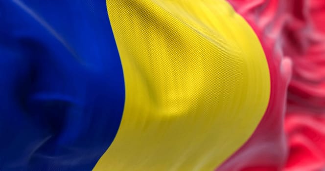 Detail of the Romania national flag waving in the wind. Romania is a Member State of the European Union. Fabric textured background. Selective focus. 3D illustration