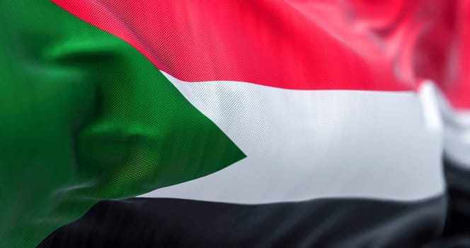 Close-up view of the Sudan national flag waving in the wind. The Republic of Sudan is a country in Northeast Africa. Fabric textured background. Selective focus. 3d illustration