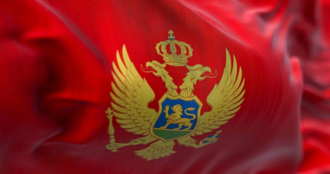 Close up view of the Montenegro national flag waving in the wind. Montenegro is a country in Southeastern Europe. Fabric textured background. Selective focus. 3D illustration