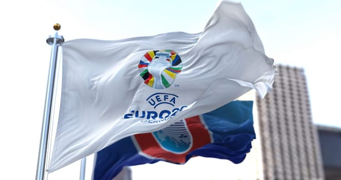 Berlin, Ger, Oct. 2022: The flag of UEFA Euro 2024 and UEFA flying in the wind. The 17th edition will take place from 14 June to 14 July 2024 in Germany. Selective focus. International sport event