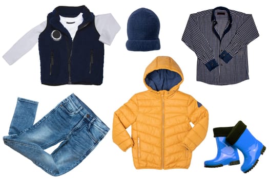 Collage set of children clothes. Denim jeans or pants, boots, a rain or down jacket, a fur vest, a shirt and a cap for child boy isolated on a white background. Concept spring autumn and winter clothes.