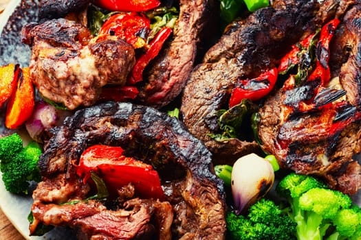 Deep fried meat with vegetable garnish. Roasted meat and vegetables. Copy space