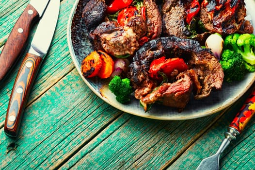 Deep fried meat with vegetable garnish. Roasted meat and vegetables. Copy space